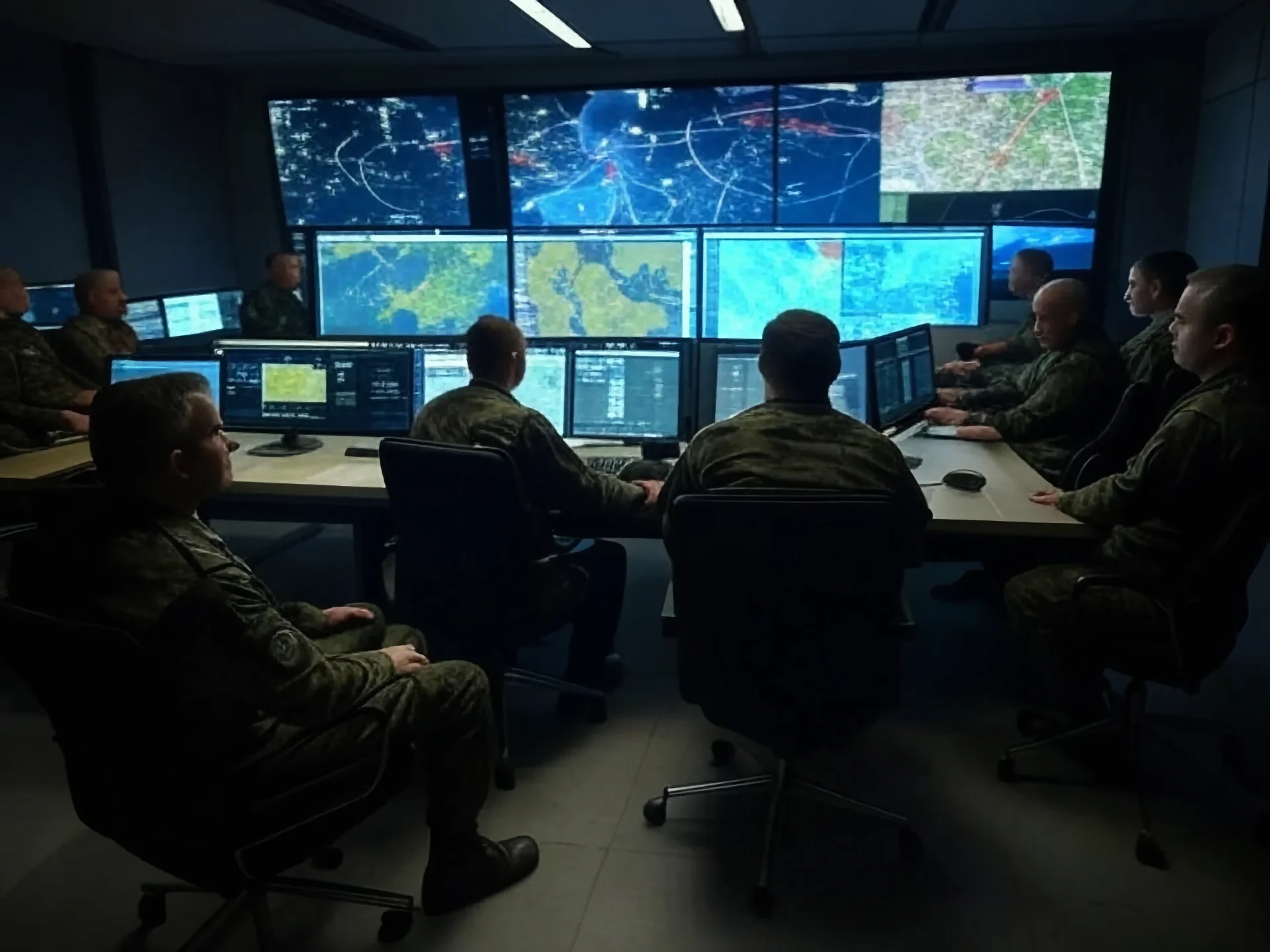 Generals and military personnel discussing wargaming strategies in control room